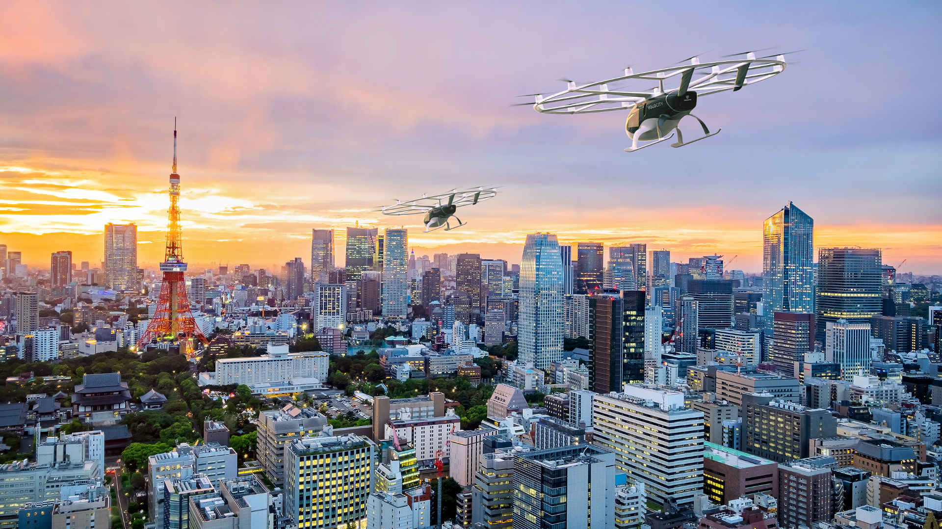 A picture of a Volocopter UAM vehicle flying over a Japanese city.